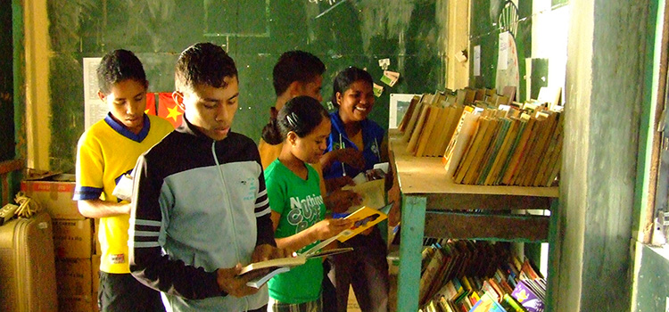 Students reading donated books in library